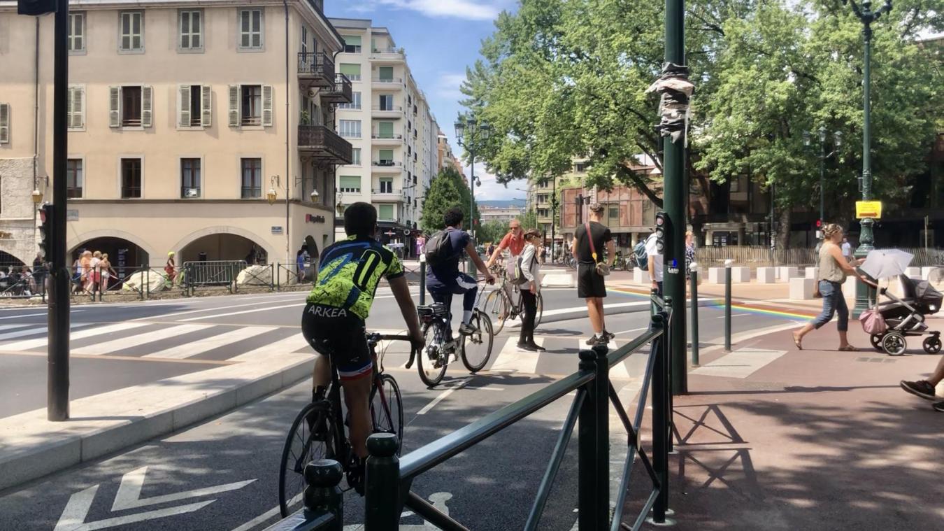Des cyclistes et des usagers de trottinette ne respectent pas le feu rouge de la piste cyclable du centre-ville.